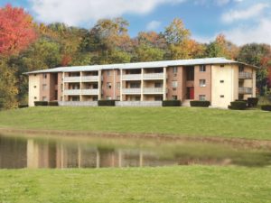 Far shot of Heritage Crystal Springs apartment with pond in Parkesburg, PA
