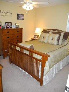 Furnished bedroom with white walls and carpet floors in Heritage Amity Commons apartments in Berks County, PA