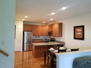 Spacious model kitchen with wood cabinets, stainless steel appliances and white walls in Bucks County, PA