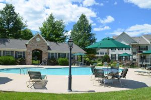 Fantastic swimming pool and tables with parasols in Heritage Greene in Bucks County, PA
