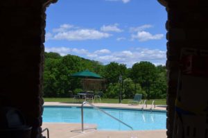 View of swimming pool from inside in Heritage Greene apartments in Sellersville, PA