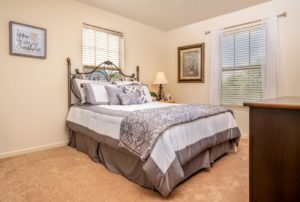 Beautiful model bedroom with carpeted flooring and sizable window in Bucks County, PA apartments
